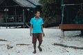 Happy cambodian man walking at the beach