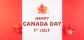 Happy Canada Day concept made from red silk maple leaves with the text on white and red background