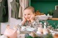 Happy candid little kid four year old girl bored with hands fists in face ready and waiting for lunch or dinner of springtime East