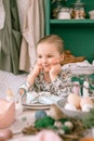 Happy candid little kid four year old girl bored with hands fists in face ready and waiting for lunch or dinner of springtime East