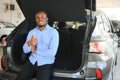 Happy Car Buyer, New Car Owner Concept. Portrait Of Excited Young African American Guy In Dealership Showroom Royalty Free Stock Photo