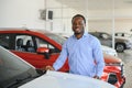 Happy Car Buyer, New Car Owner Concept. Portrait Of Excited Young African American Guy In Dealership Showroom Royalty Free Stock Photo