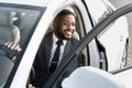 African Businessman Getting Out Of Automobile Opening Auto Door