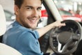 Happy car owner at the dealership. Handsome young men sitting at Royalty Free Stock Photo