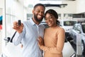 Happy Car Owners. Portrait Of Young Black Couple Posing With Automobile Keys Royalty Free Stock Photo