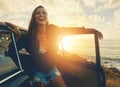 Happy, car and woman on a road trip at the beach for summer, freedom and travel in Spain. Smile, adventure and girl