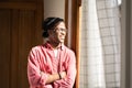 Happy carefree African American man stands in own house near window rejoicing at sunny weather Royalty Free Stock Photo