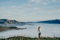 Happy carefree asian woman enjoying nature with layers of mountains and the mist in the morning at The peak of Bank Peninsula, Royalty Free Stock Photo