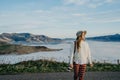 Happy carefree asian woman enjoying nature with layers of mountains and the mist in the morning at The peak of Bank Peninsula, Royalty Free Stock Photo