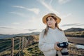 Happy carefree asian woman enjoying nature with layers of mountains and the mist in the morning at The peak of Bank Peninsula, Royalty Free Stock Photo