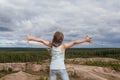 Happy carefree child girl against sky clouds outdoors