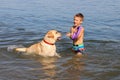 happy and carefree childhood. Happy boy with golden retriever labrador dog swims Royalty Free Stock Photo