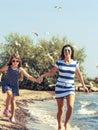 Happy carefree family running on beach at sea. Royalty Free Stock Photo