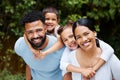 Happy, carefree and fun family playing, bonding and enjoying a day in a nature park together on the weekend in summer Royalty Free Stock Photo