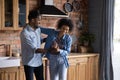 Happy carefree millennial African family couple dancing in kitchen. Royalty Free Stock Photo