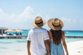 Happy and carefree unrecognizable couple enjoying a sunny summer day at the beautiful beach