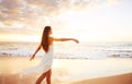 Happy Carefree Woman on the Beach at Sunset