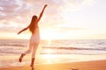 Happy Carefree Woman Dancing on the Beach at Sunset