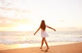 Happy Carefree Woman Dancing on the Beach at Sunset