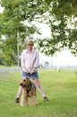 Happy carefree woman walking best friend dog in countryside Royalty Free Stock Photo