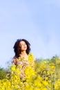 Happy carefree young beautiful girl basking in the sun in the field Royalty Free Stock Photo