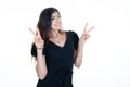 Happy carefree young woman making peace sign with two fingers hands standing isolated over white background in Victory gesture Royalty Free Stock Photo