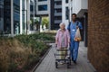 Happy caregiver caming back from grocery with his senior woman client. Royalty Free Stock Photo