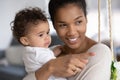 Happy caring African American mom hold little baby Royalty Free Stock Photo