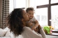 Happy African American mom caress little toddler daughter Royalty Free Stock Photo