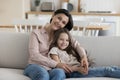 Happy caring grandma hugging positive adorable little kid girl