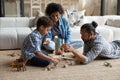 Loving African American parents playing toys with kid son. Royalty Free Stock Photo