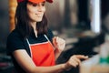 Fast Food Vendor Using the Cash Register Royalty Free Stock Photo