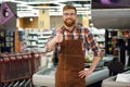 Happy cashier man on workspace shop showing thumbs up. Royalty Free Stock Photo