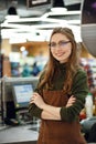 Happy cashier woman on workspace in supermarket shop Royalty Free Stock Photo