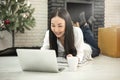 Happy casual beautiful asian woman working from home on a laptop Royalty Free Stock Photo