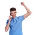 Happy casual man celebrating good news on the phone Royalty Free Stock Photo