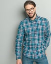 happy casual man with glasses wearing plaid shirt and smiling Royalty Free Stock Photo