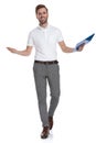 Happy casual man holding a clipboard is walking and welcoming Royalty Free Stock Photo