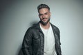 Happy casual man posing with a black leather jacket Royalty Free Stock Photo