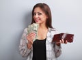 Happy casual woman holding dollars and wallet in hands and want Royalty Free Stock Photo