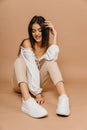 Happy casual woman lying on the floor over pastel background. Lady, cute. Provence concept. High quality photo