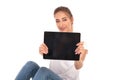 Happy casual woman showing the blank screen of a tablet Royalty Free Stock Photo