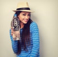 Happy casual woman in summer hat holding bottle of pure water an Royalty Free Stock Photo