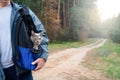 Happy cat travels in a backpack with a man in the woods. walking Pets during a virus pandemic . care of Pets. tourist cat with red Royalty Free Stock Photo