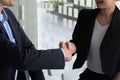 Happy caucasia male and asian female hand shaking, successful businessman handshake after good deal for both companies Royalty Free Stock Photo