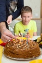 Happy Caucasian boy celebrating his birthday and ready to blow candles on homemade baked cake Royalty Free Stock Photo