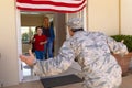 Happy caucasian boy running towards military father\'s arrival at the entrance of their house Royalty Free Stock Photo