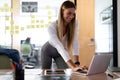 Happy caucasian businesswoman standing at desk having video call conversation using laptop Royalty Free Stock Photo