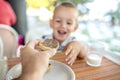 Happy Caucasian child eating bread with chocolate for breakfast Royalty Free Stock Photo