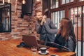 Happy caucasian colleagues giving high five, celebrating success reading good news on line in a laptop or teamwork result Royalty Free Stock Photo